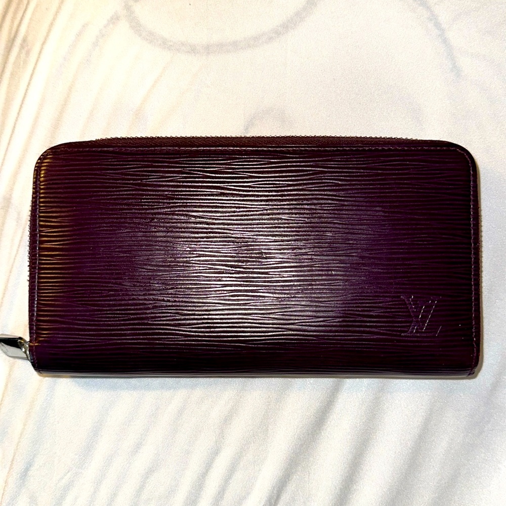 Louis Vuitton Purple Epi zippered wallet with box.